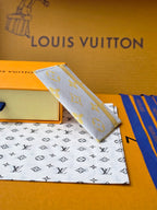 Louis Vuitton small bag with light blue monogram canvas and yellow trim, tilted view