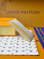 Louis Vuitton small bag with light blue monogram canvas, shown from the side on a box