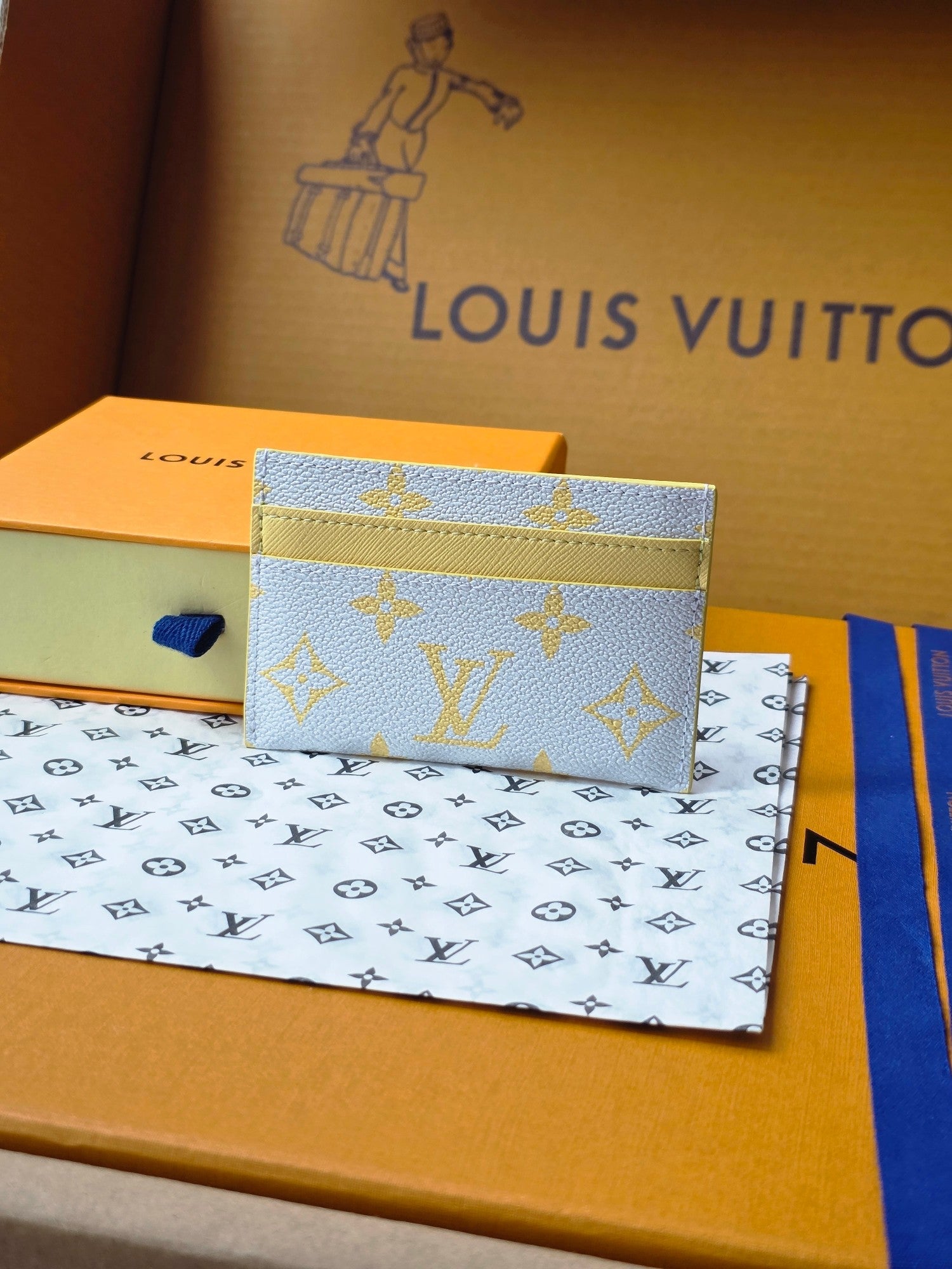 Louis Vuitton small bag in light blue monogram canvas with yellow trim, front view