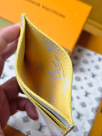 Louis Vuitton small bag close-up, interior view with yellow lining and blue monogram