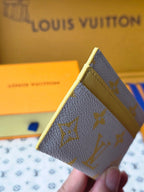 Louis Vuitton small bag angled view with blue monogram canvas and yellow interior