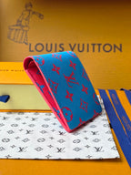 Small card wallet with blue patterned exterior and red underside, angled view.