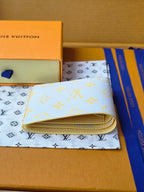 Small card wallet open, showing card slots and beige lining inside