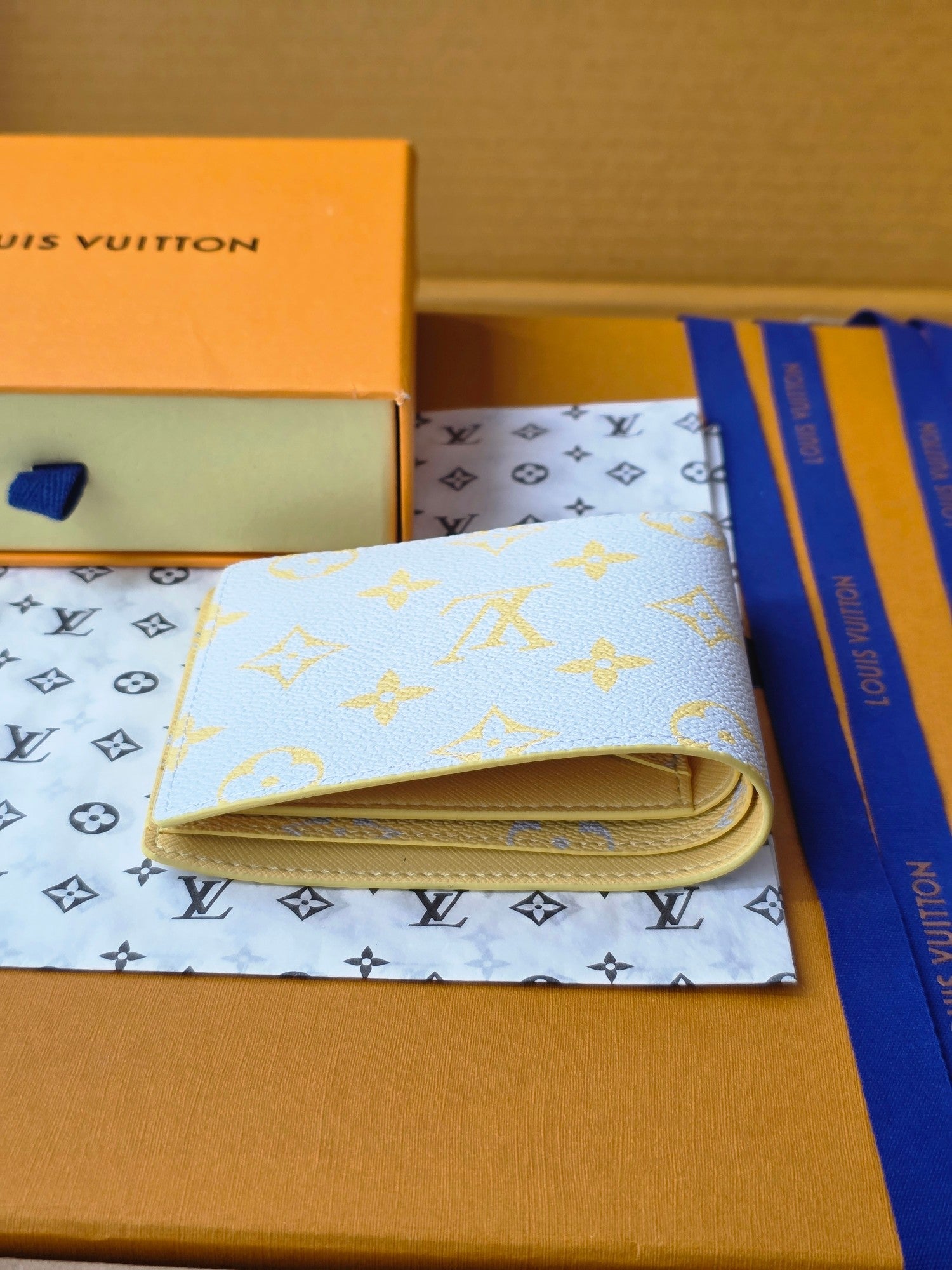 Small card wallet open, showing card slots and beige lining inside