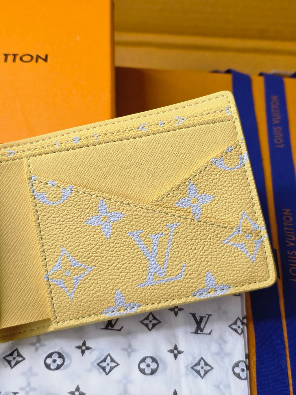 Small card wallet close-up of front, beige leather with blue monogram pattern