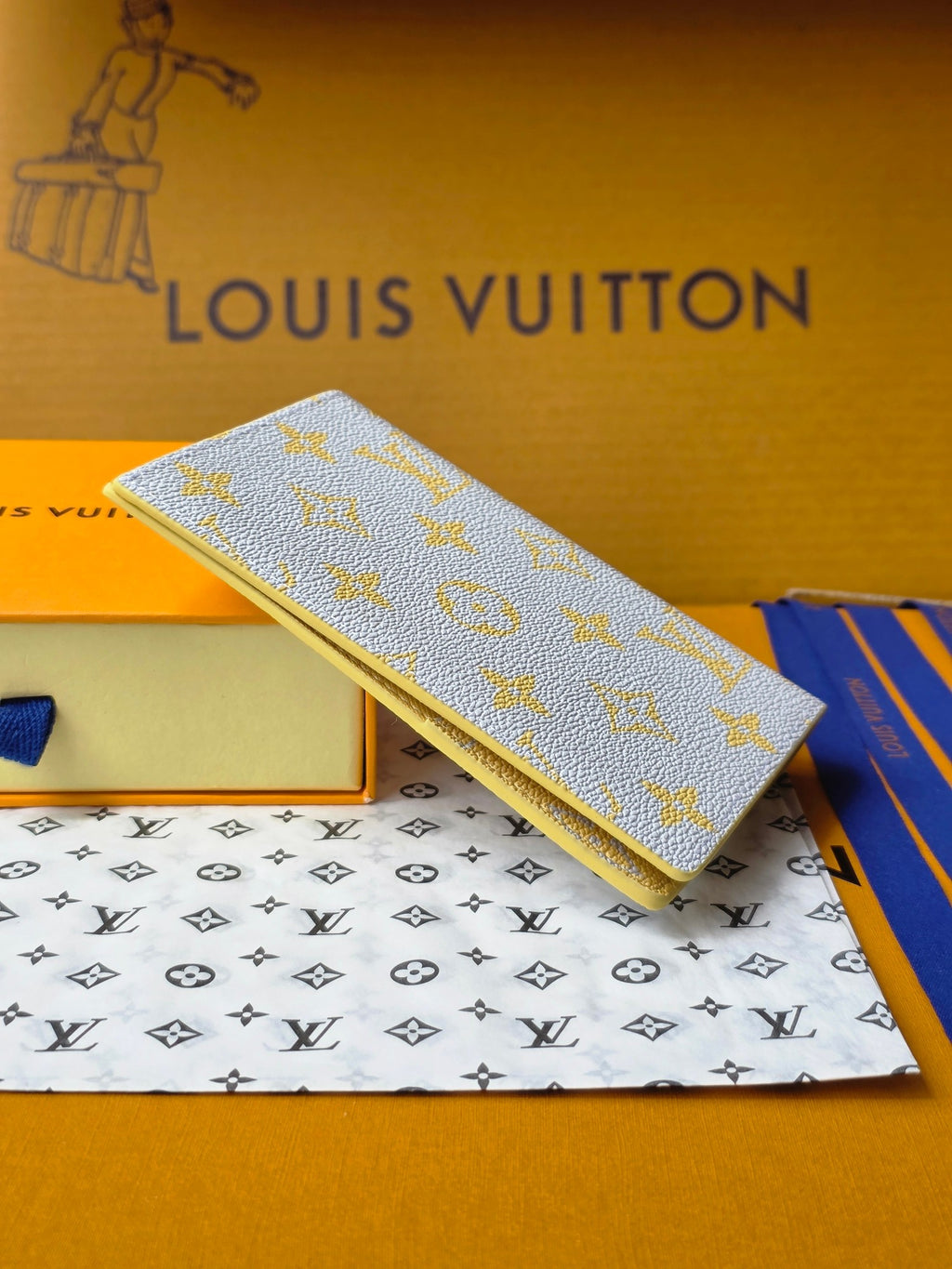 Small bag: yellow card holder with blue monogram, angled view with gold edge