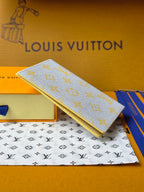 Small bag: yellow card holder with blue monogram, angled view with gold edge