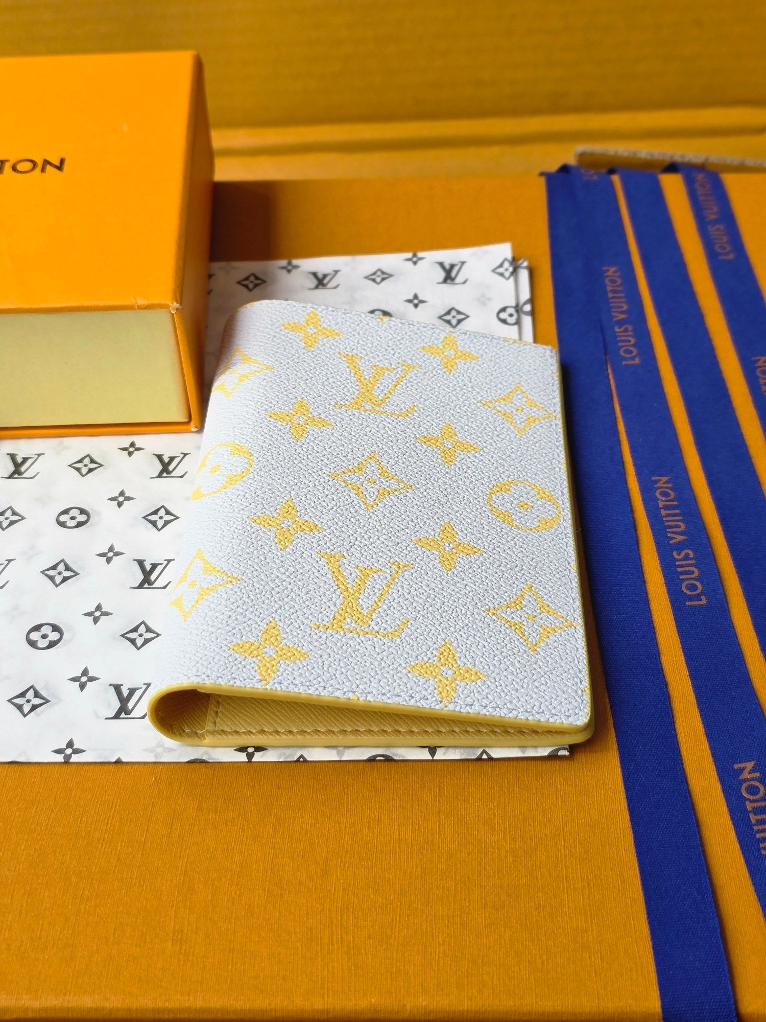 Small bag: yellow card holder with blue monogram, top view with gold hardware