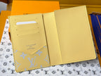 Small bag: yellow leather card case with blue monogram and interior slots, open