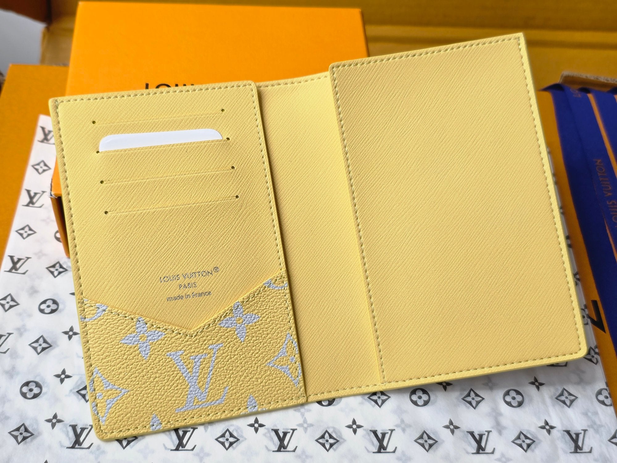 Small bag: yellow leather card case with blue monogram and interior slots, open