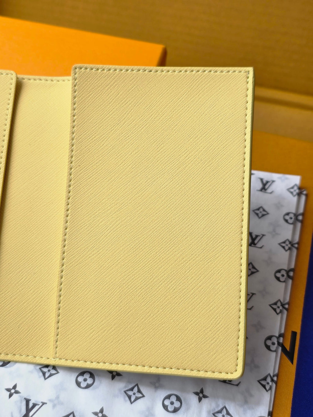Small bag: yellow card case interior panel with stitching, close-up