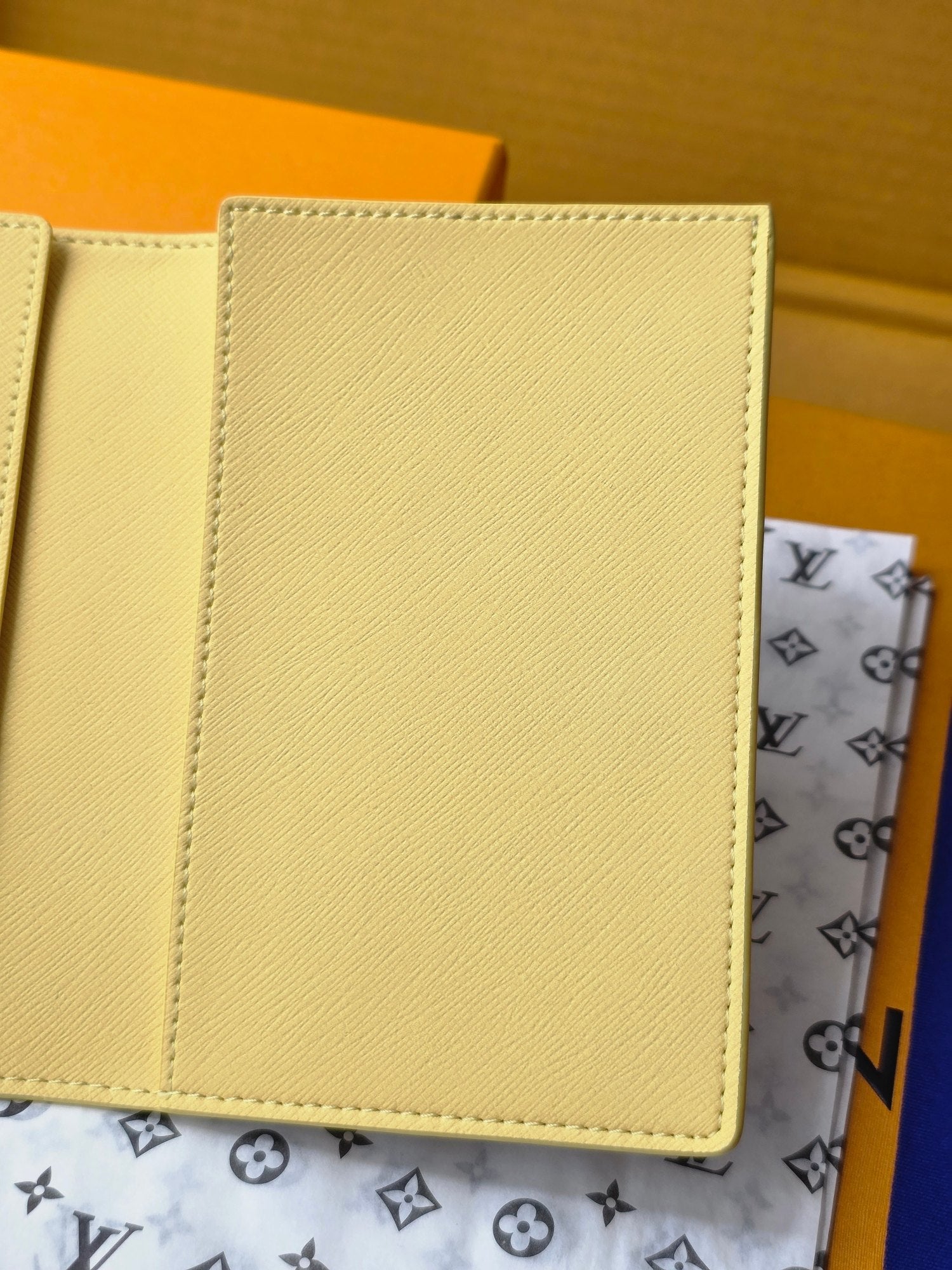 Small bag: yellow card case interior panel with stitching, close-up