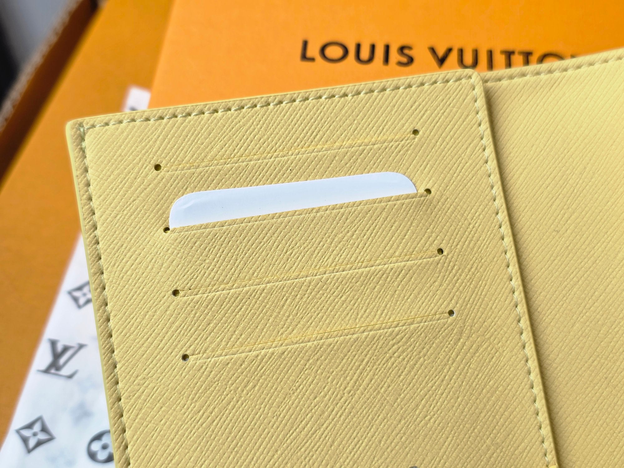 Small bag: Louis Vuitton yellow card case, top card slot detail close-up
