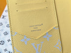 Small bag: Louis Vuitton yellow card case with blue monogram border and logo, close-up