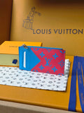 Small bag clutch with blue and pink monogram pattern, zipper closure and blue strap