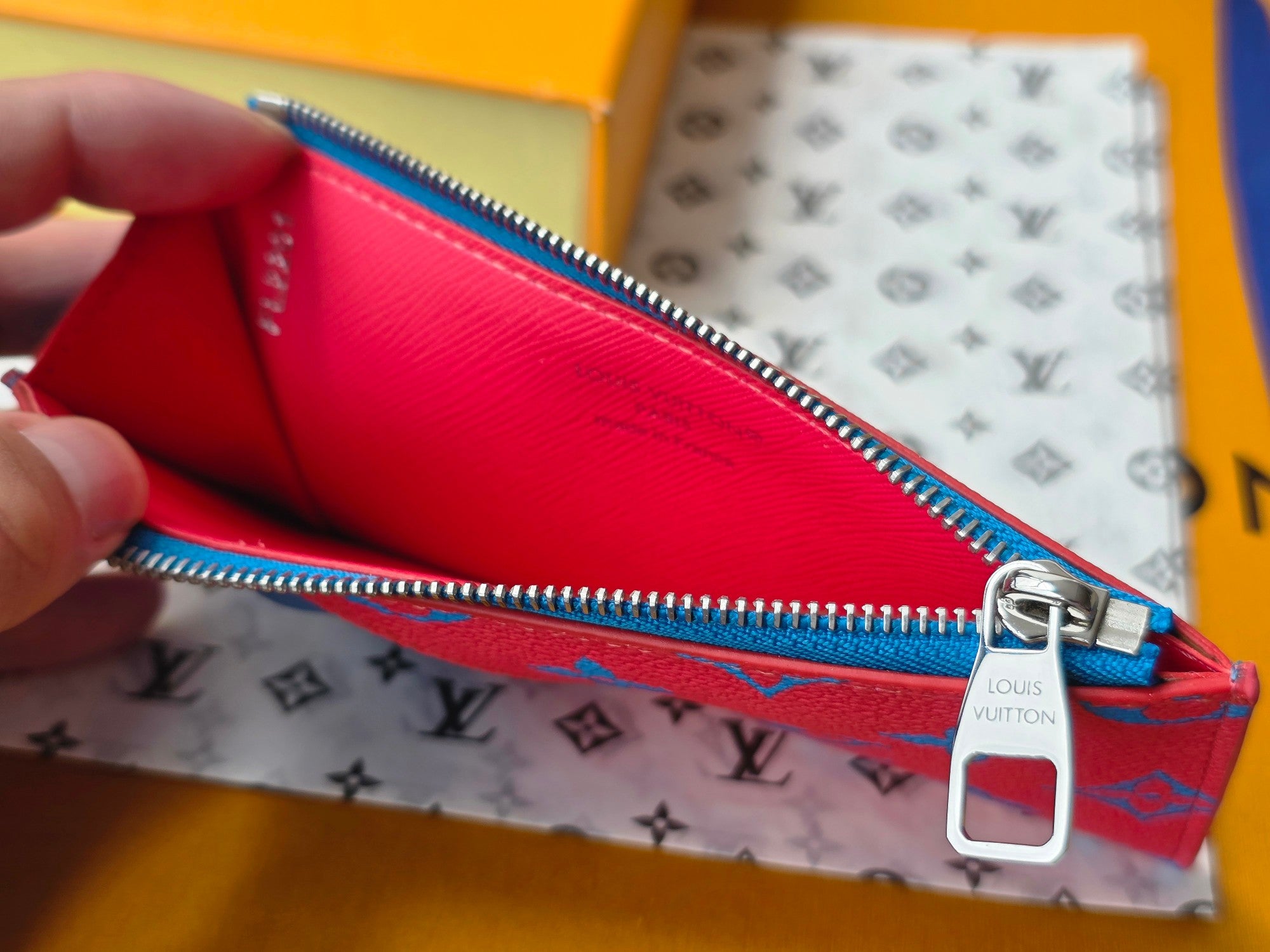Small bag open view with pink interior lining and silver zipper hardware