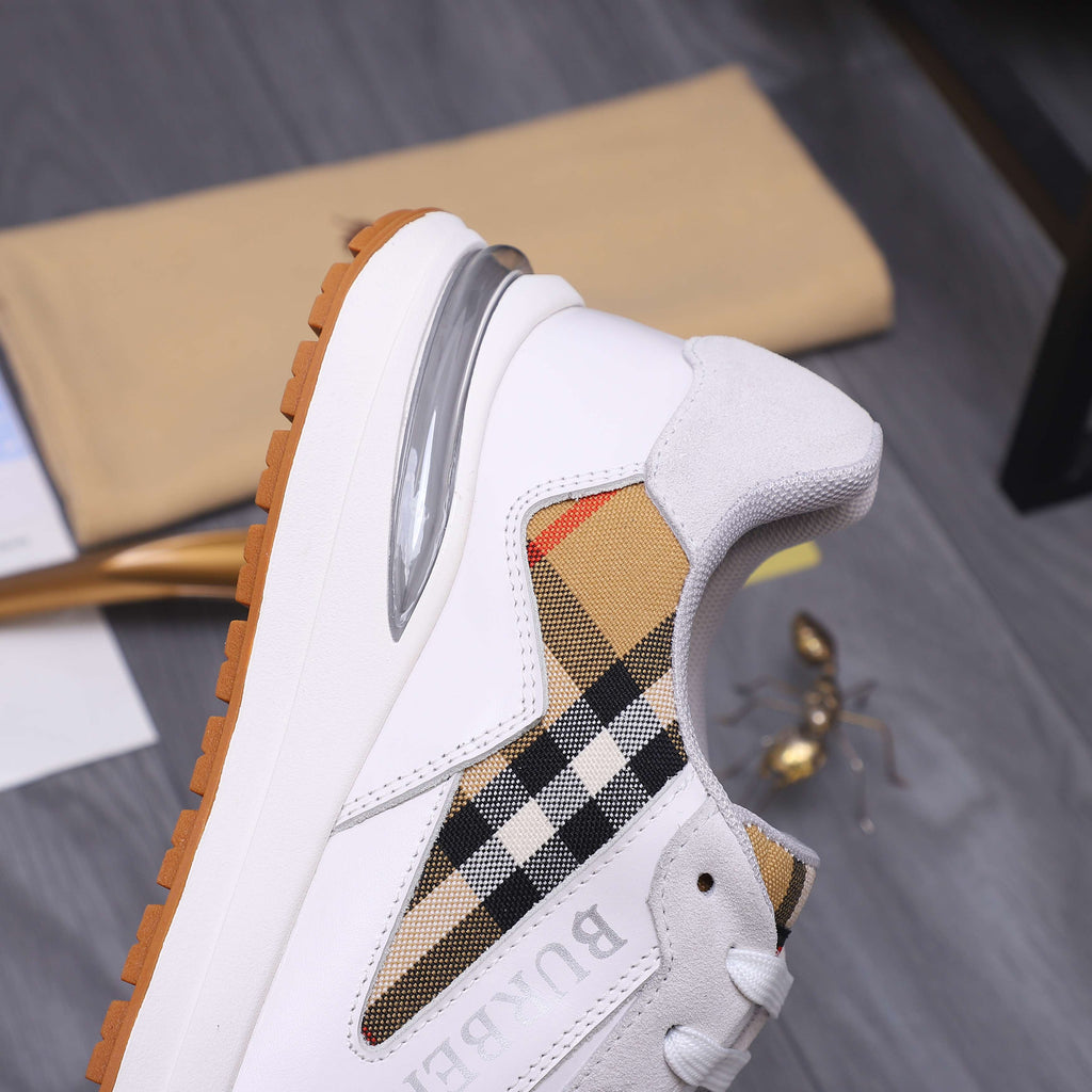 White Burberry sneaker with black-and-tan plaid side panel and gum edge sole