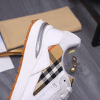 White Burberry sneaker with black-and-tan plaid side panel and gum edge sole
