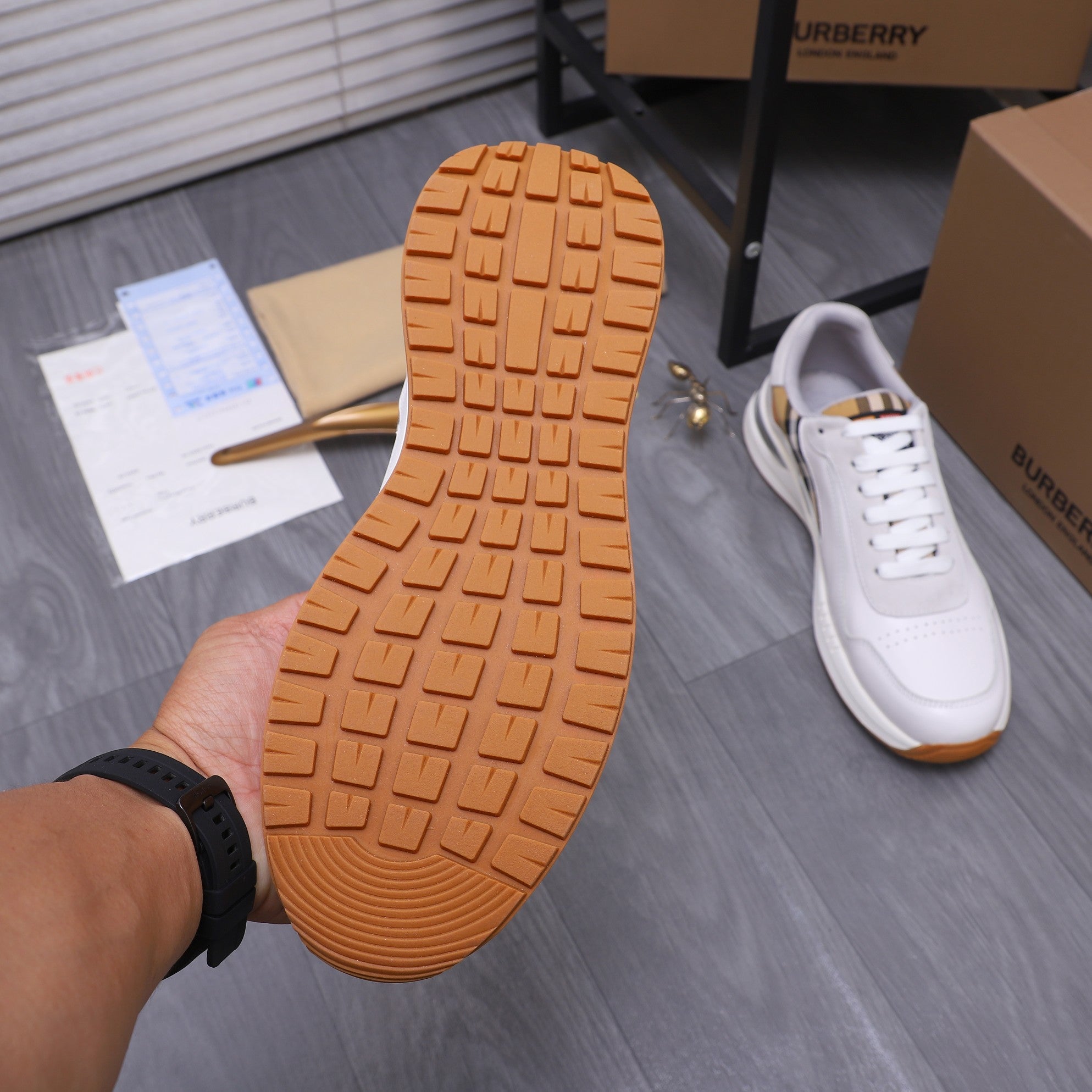 Burberry sneaker outsole with textured tread and white upper with lace-up front