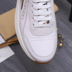 White Burberry low-top sneaker close-up with perforated toe and stitching details