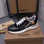 Black luxury sneakers with white laces, check collar lining, and white rubber sole