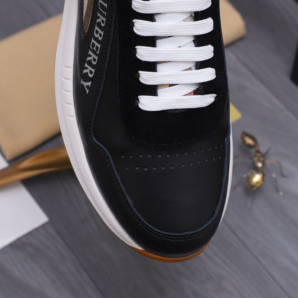 Close-up of black luxury sneaker side with white laces and contrast panel stitching
