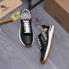 Black luxury sneakers with check-pattern tongue detail, white laces, and rubber sole