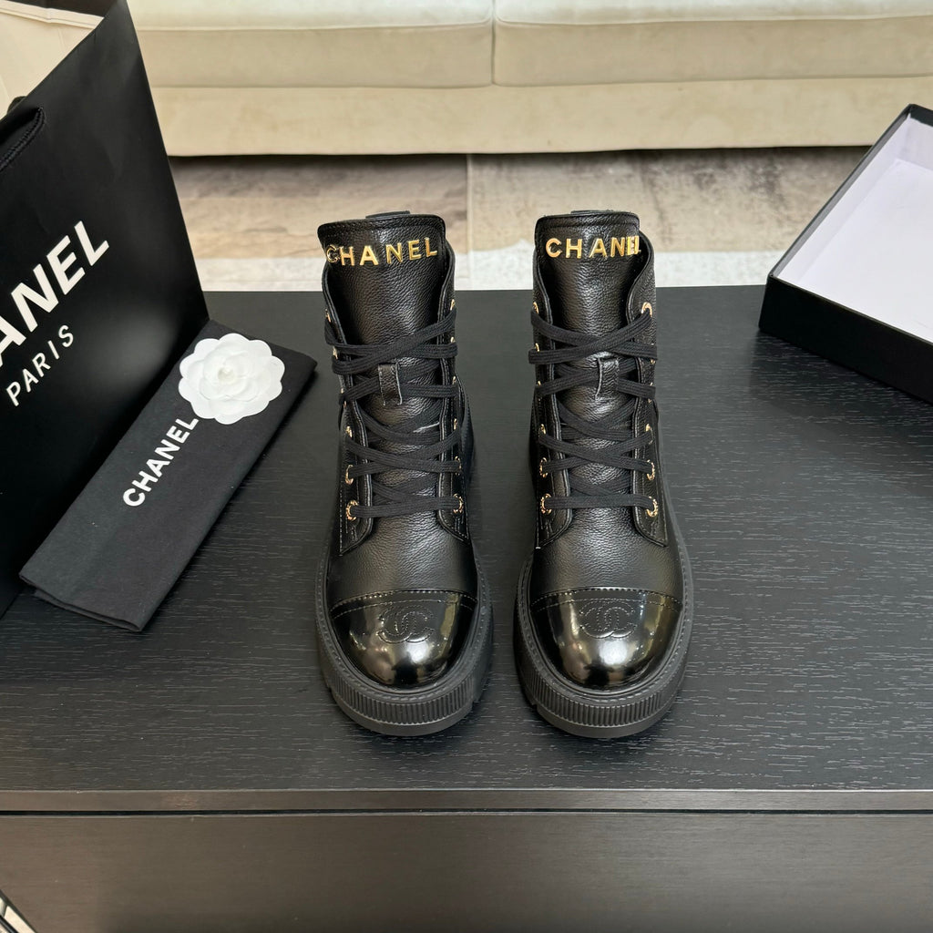 Black leather lace-up ankle boots with Chanel logo, gold eyelets