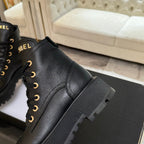 Black leather lace-up ankle boots with ribbed side panel and chunky rubber sole