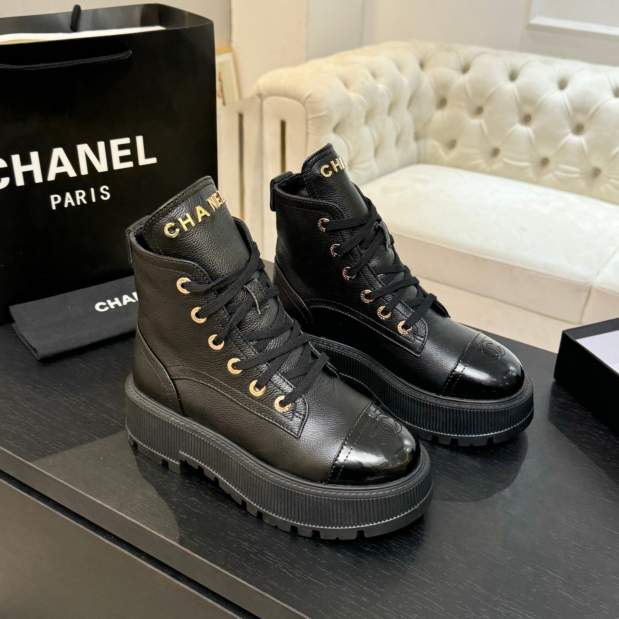 Black leather lace-up ankle boots with glossy toe caps and chunky platform sole