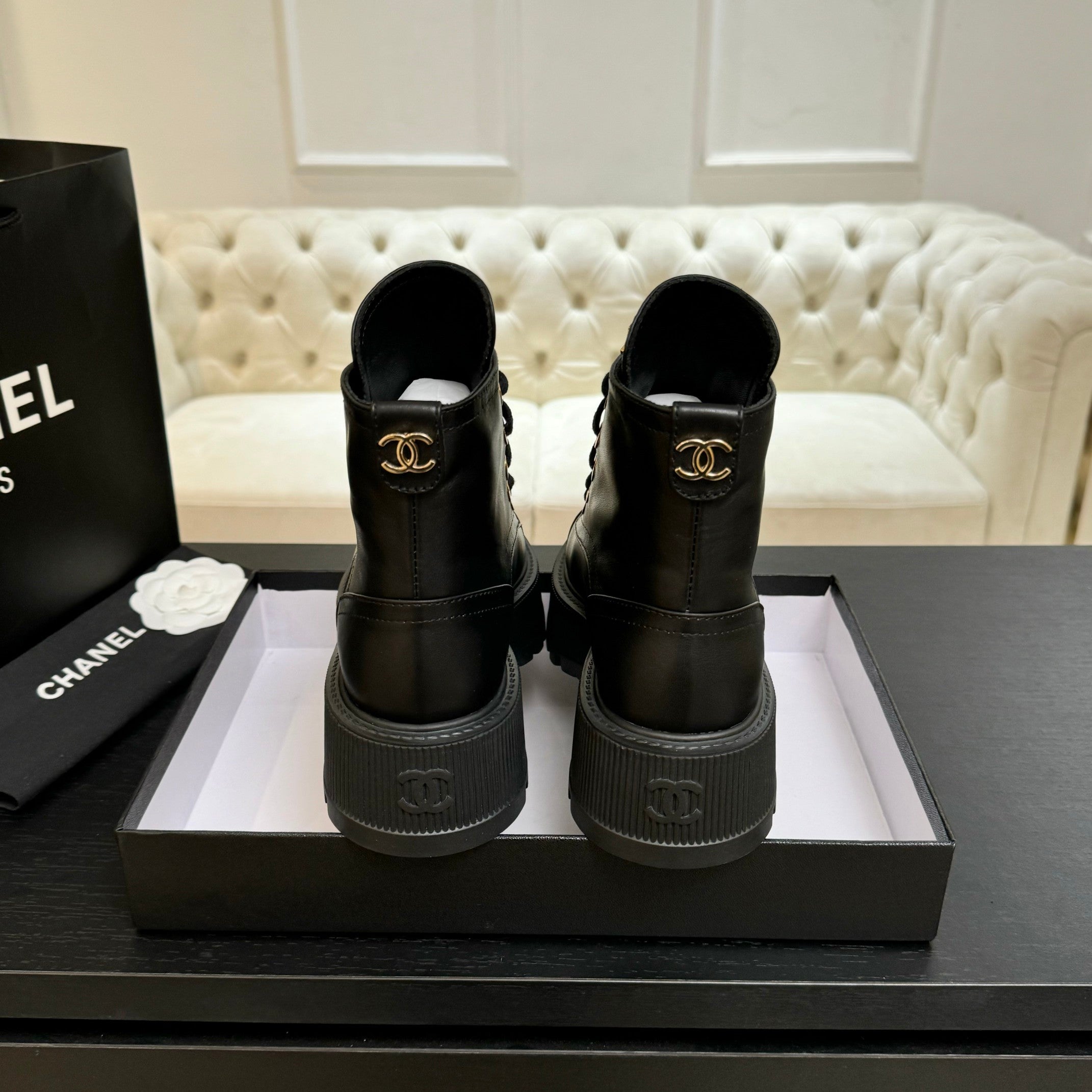 Chanel black leather lace-up ankle boots with back pull tabs on platform soles