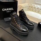 Chanel black leather lace-up ankle boots on thick rubber platform soles