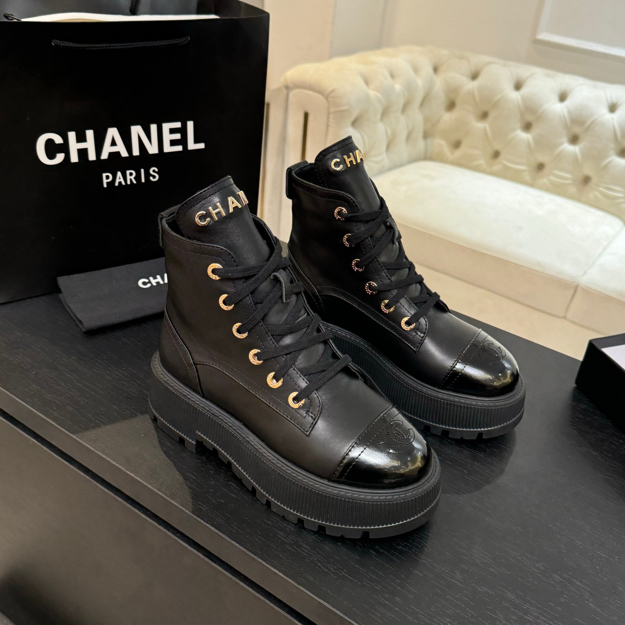 Chanel black leather lace-up ankle boots on thick rubber platform soles