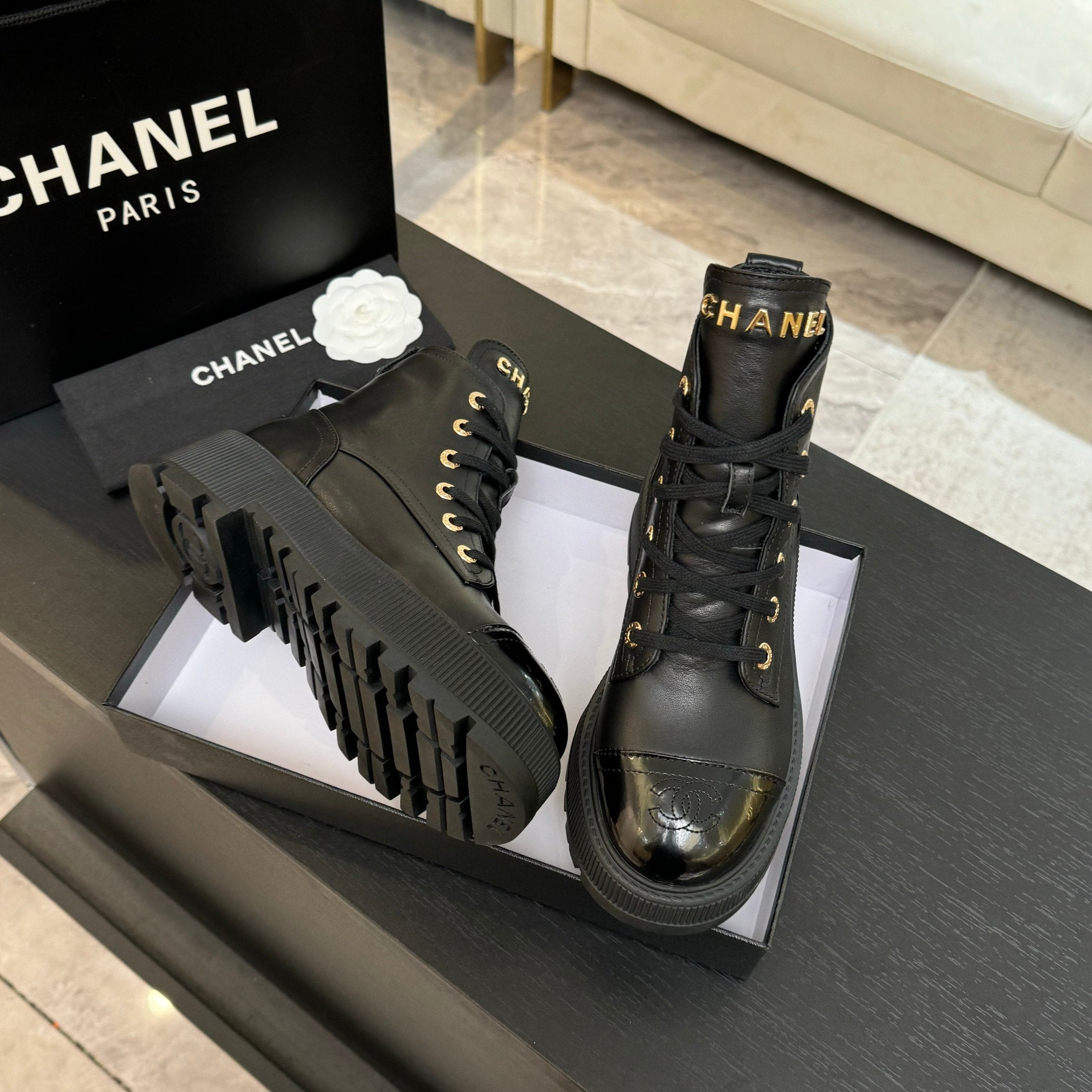 Chanel black leather lace-up ankle boots with chunky treaded outsoles