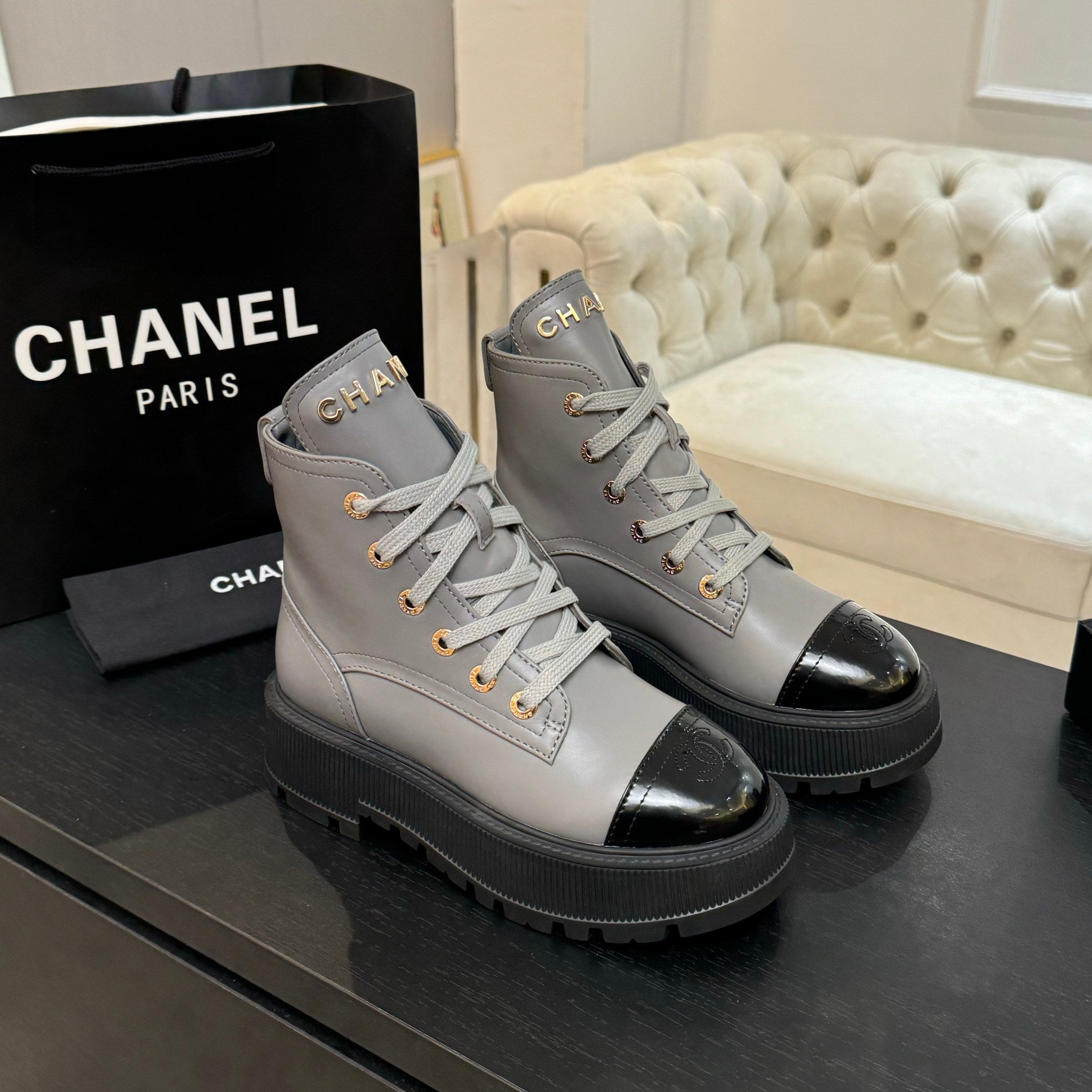 Chanel ladies high-top sneakers in light gray with black toe cap, lace-up design