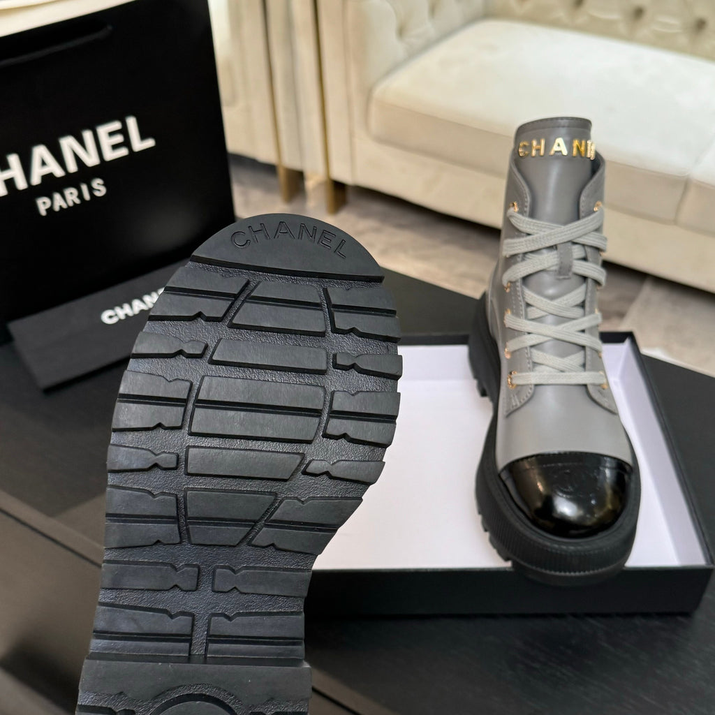 Chanel ladies high-top sneaker outsole tread with one light gray shoe in view