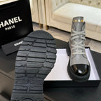 Chanel ladies high-top sneaker outsole tread with one light gray shoe in view