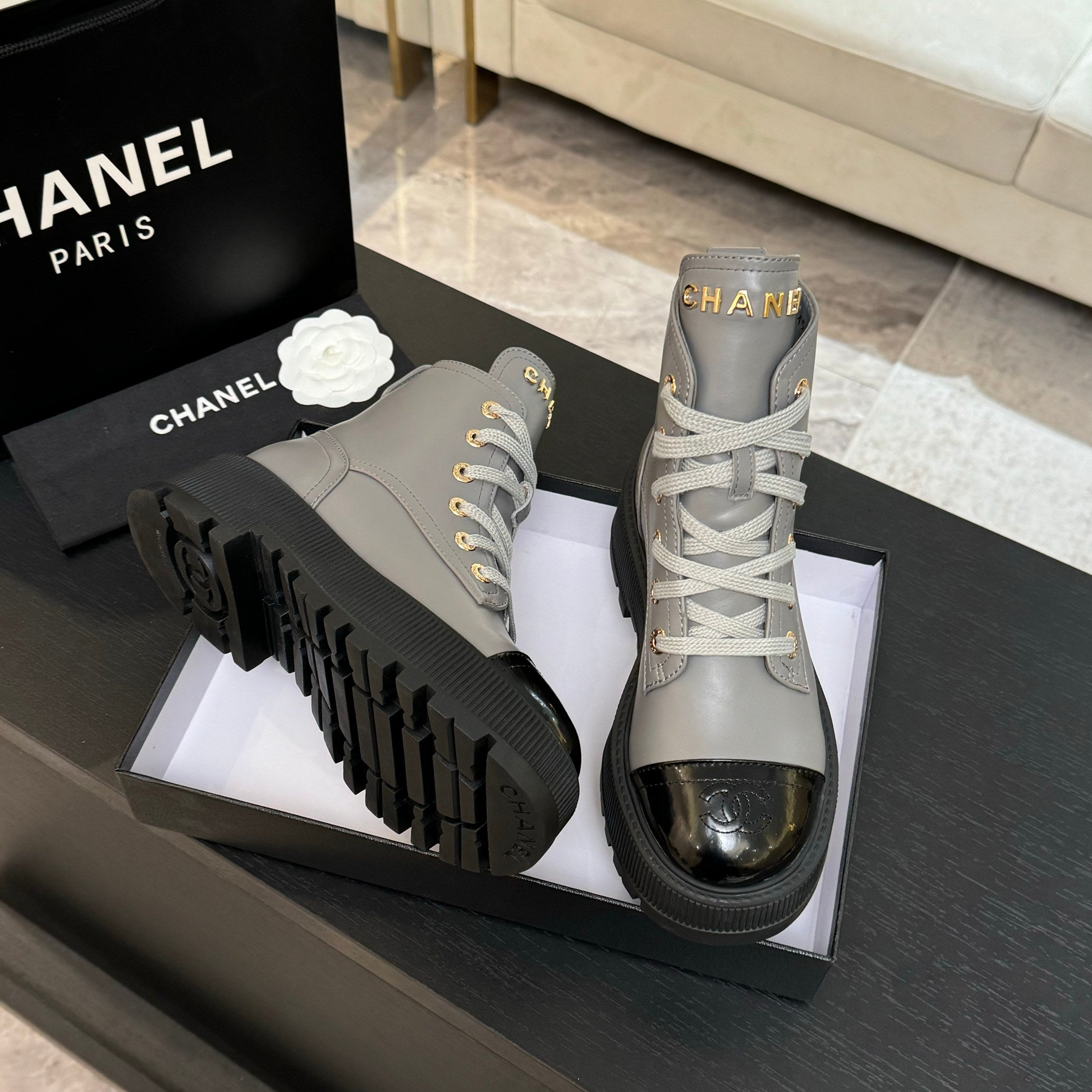 Chanel ladies high-top sneakers, light gray uppers with black toe caps and thick tread soles