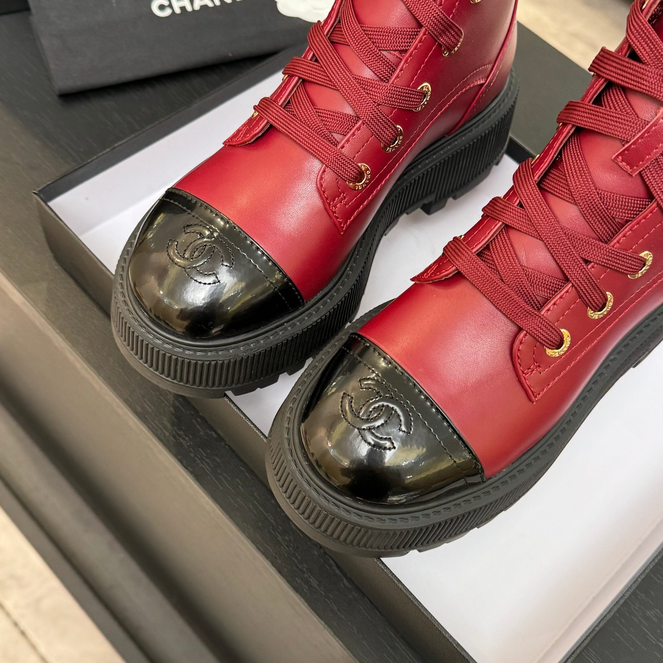 Chanel ladies red lace-up high-top boot close-up with gold laces and rubber platform