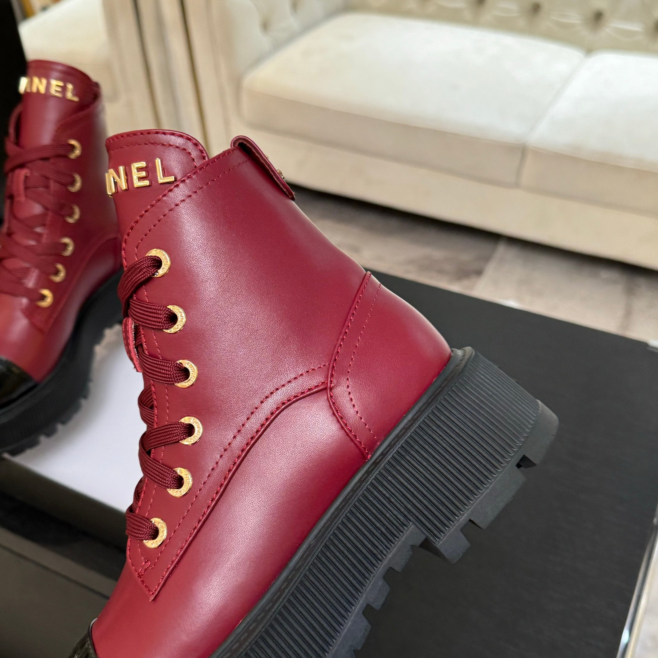 Chanel ladies red lace-up high-top boot side view with gold eyelet lacing