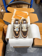 Pair of Louis Vuitton trainer sneakers, dark brown with white laces, on a white holder