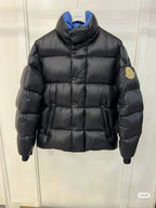 Moncler long puffer jacket with hood, dark quilted fabric, front zipper, sleeve logo patch