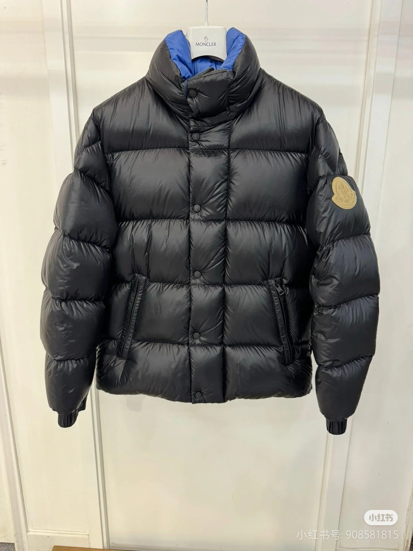 Moncler long puffer jacket with hood, dark quilted fabric, front zipper, sleeve logo patch