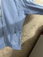 Light blue zip-up hoodie with side pocket and ribbed hem