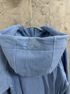 Light blue hoodie hood with raised emblem and drawstring