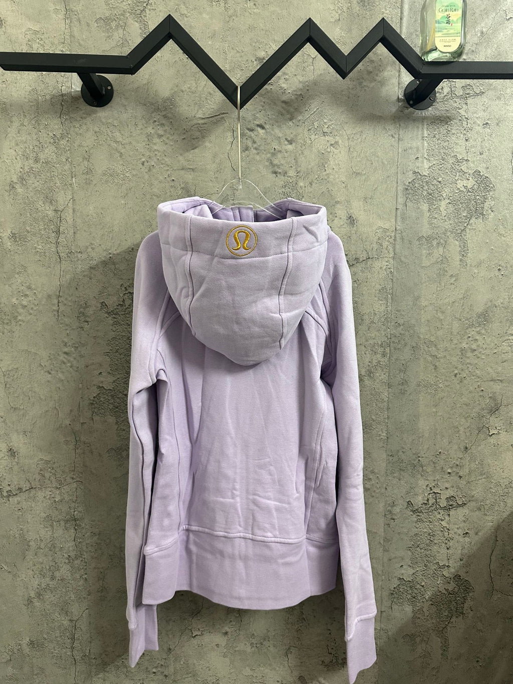 Light purple hooded zip-up jacket with front zipper and kangaroo pocket