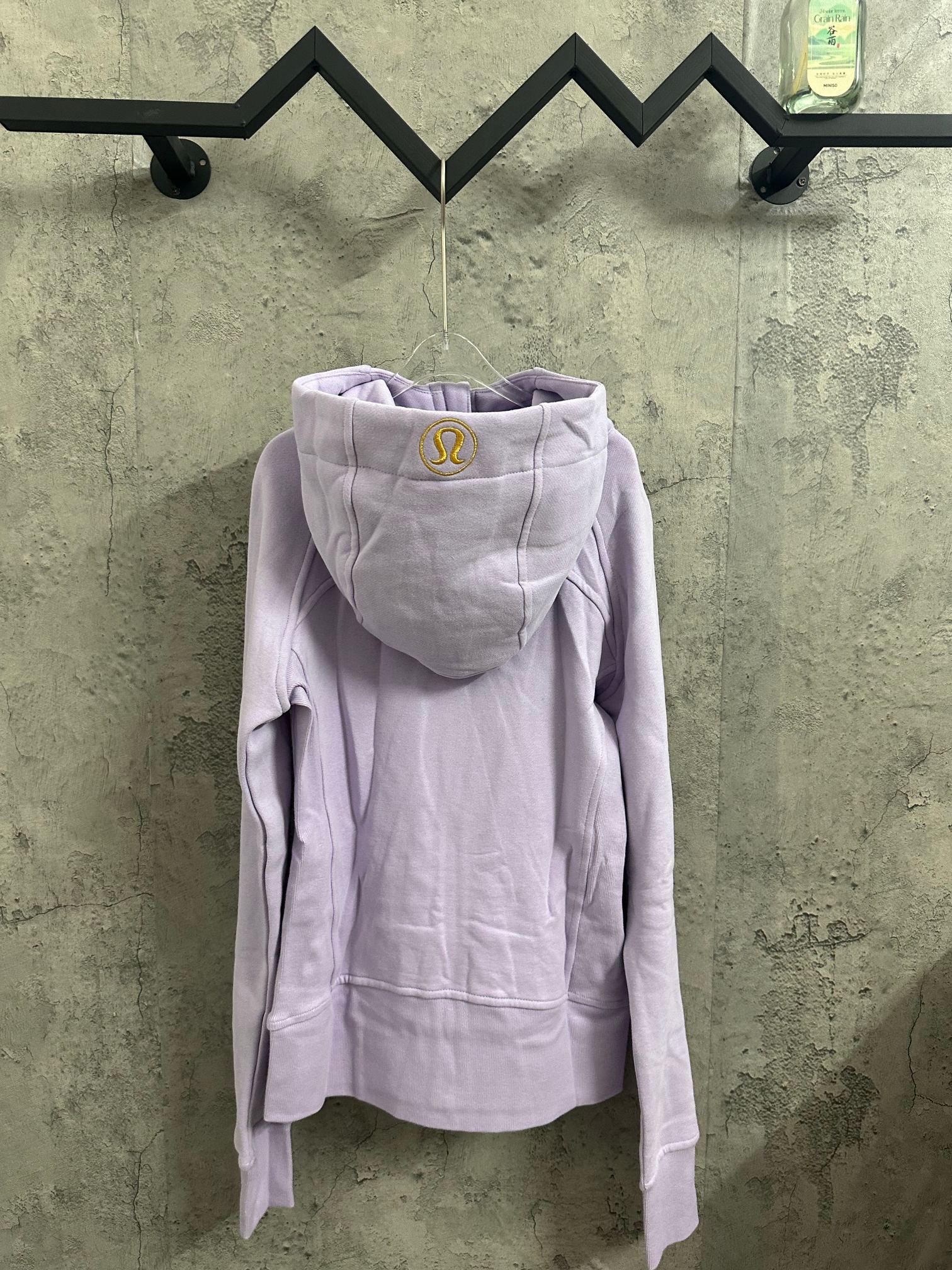 Light purple hooded zip-up jacket with front zipper and kangaroo pocket