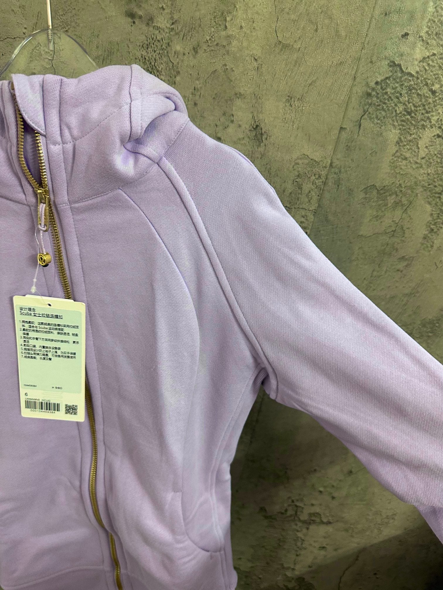 Light purple hoodie close-up: shoulder and sleeve with ribbed cuff