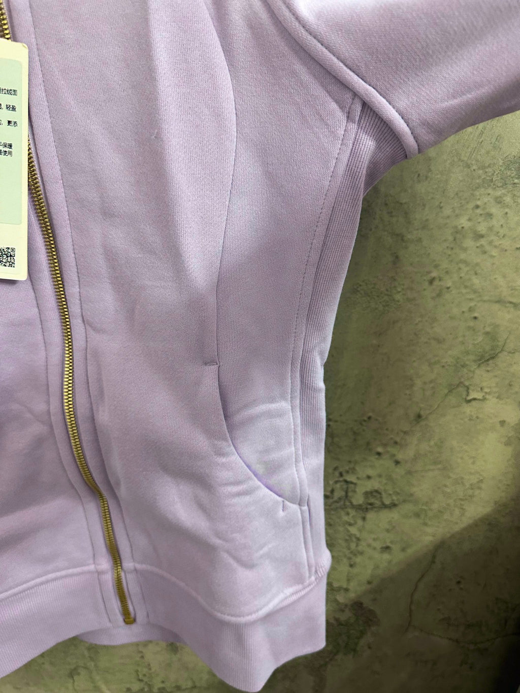 Light purple zip-up hoodie with kangaroo pocket and side seam detail
