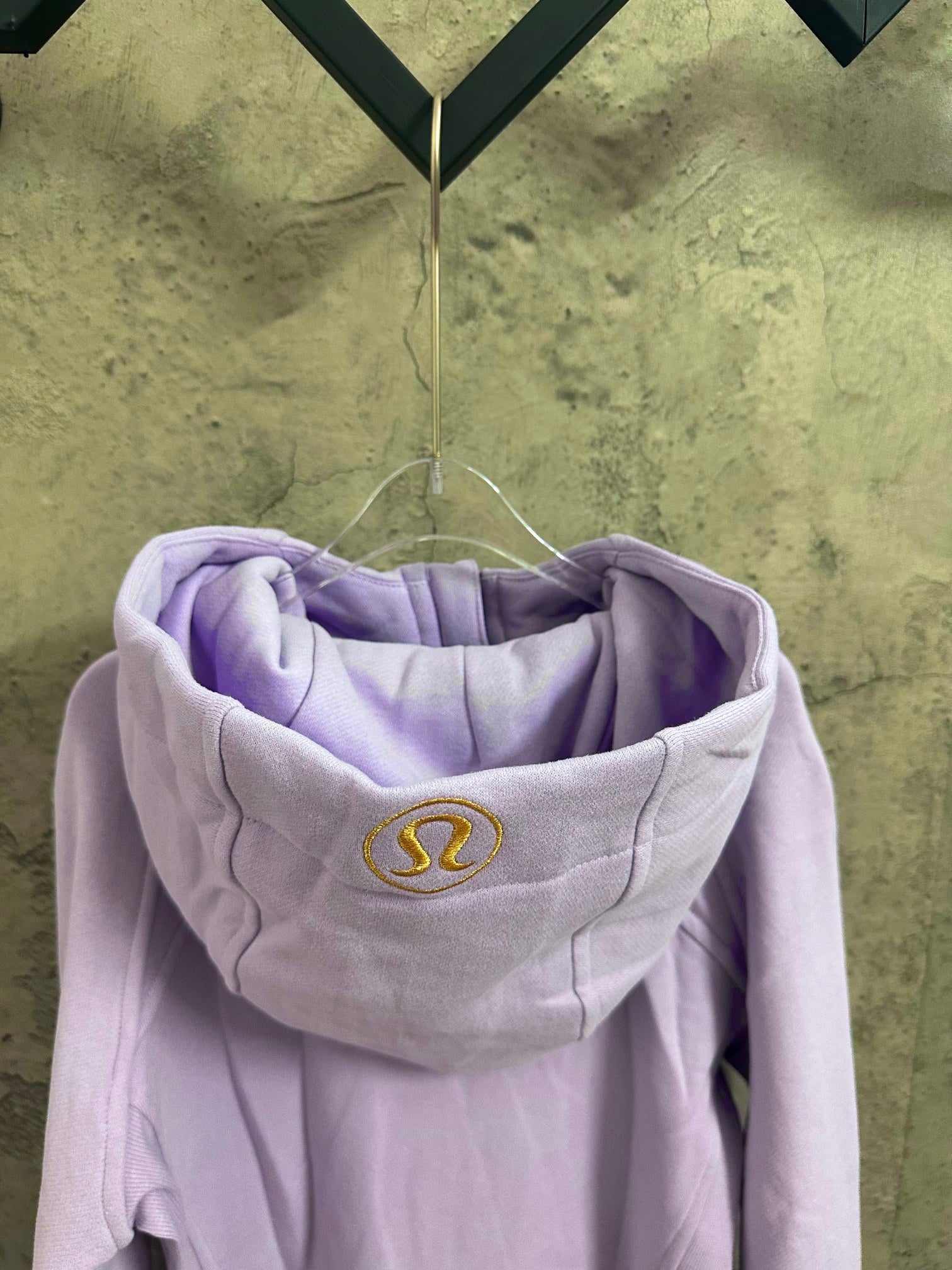 Light purple hoodie with hood and small embroidered logo on chest